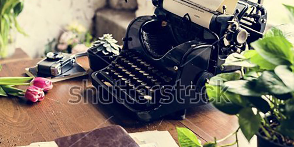 stock-photo-retro-typewriter-machine-old-style-by-tulips-flower-652594258